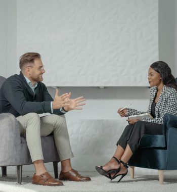 pexels-photo-5336951-5336951 A candid interaction between a man and woman during a professional interview in a modern office setting.