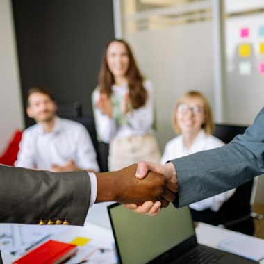 pexels-photo-7792841-7792841 Close-up of a handshake between colleagues in a professional office setting, emphasizing teamwork and agreement.